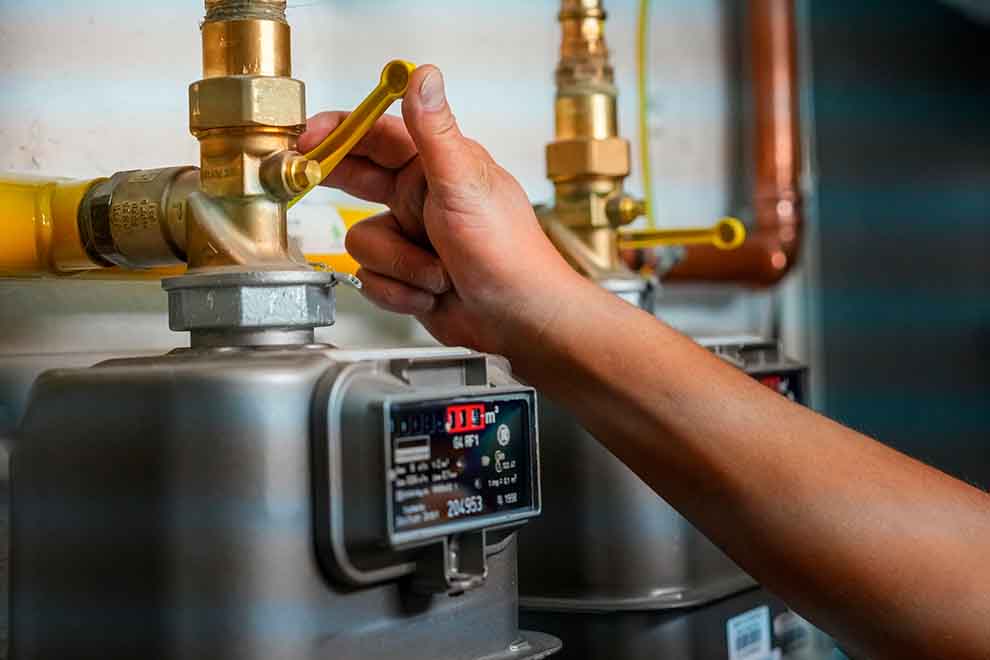 verifique se o gás está desligado  pessoa fechando o registro de gás em uma cozinha em um dia nublado